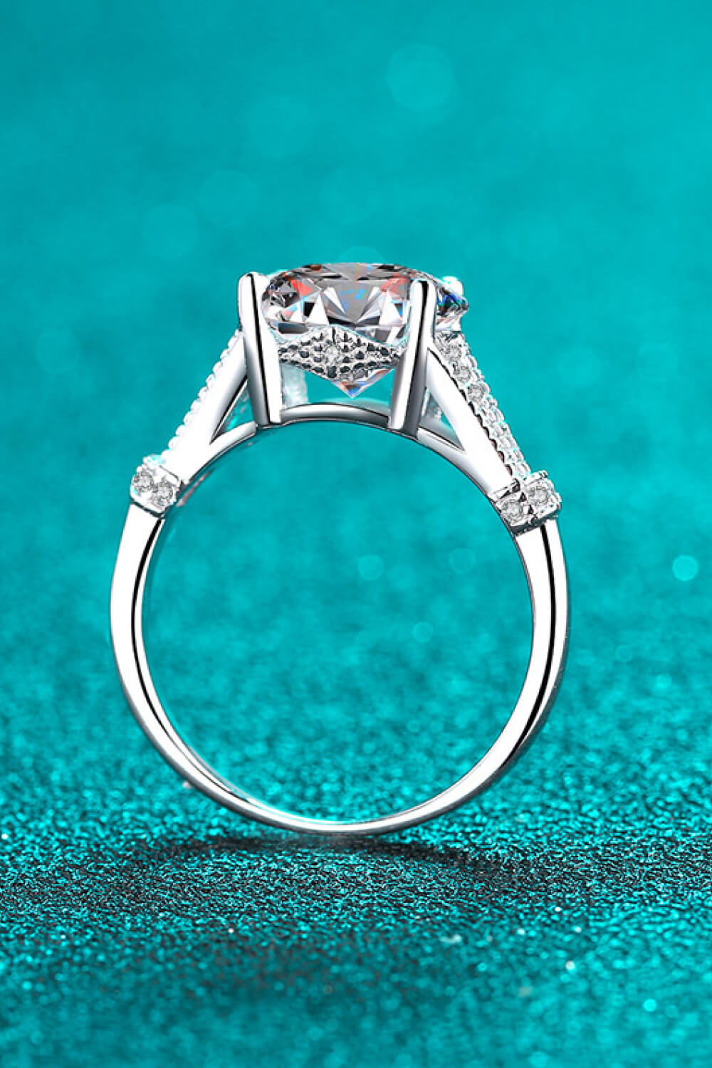 Silver pavé-set moissanite solitaire ring with 925 sterling silver band.