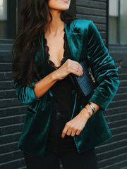 Emerald velvet blazer with black lapels and button front, styled with black lace top.
