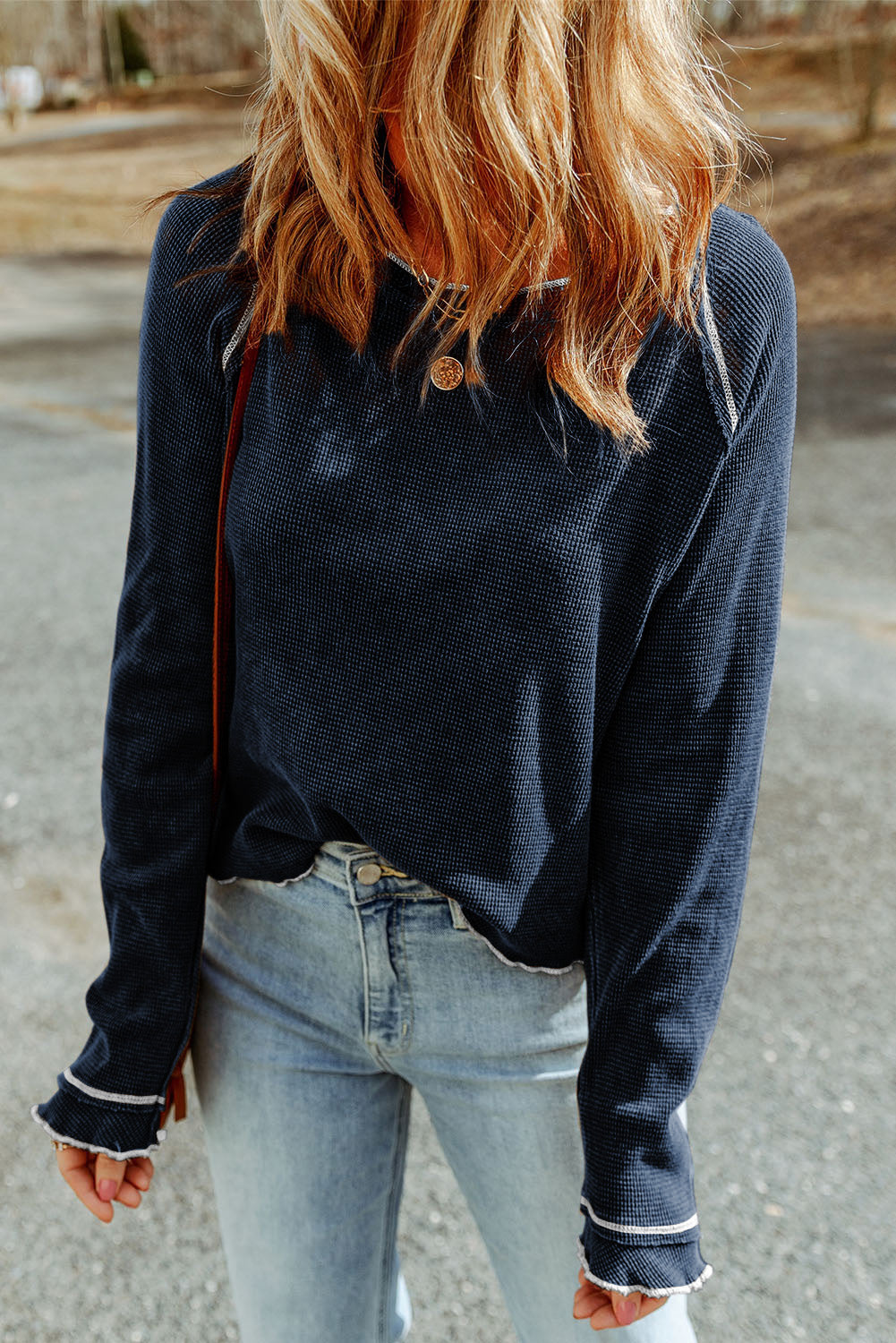 Navy waffle knit raglan sweater with ruffled cuffs and contrast stitching