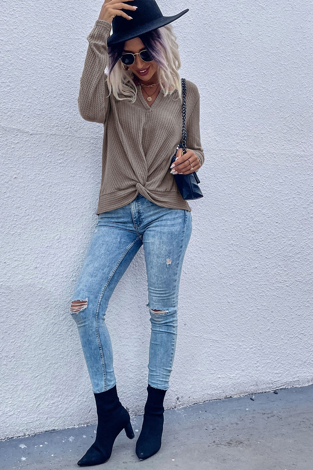 Knot-front waffle knit top in coffee brown with V-neck and long sleeves.