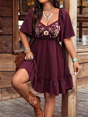 Wine red flutter sleeve dress with floral embroidery and ruffled hem.