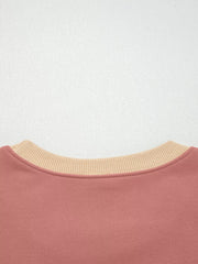 Dusty pink sweatshirt with contrast tan ribbed crewneck and exposed seams.