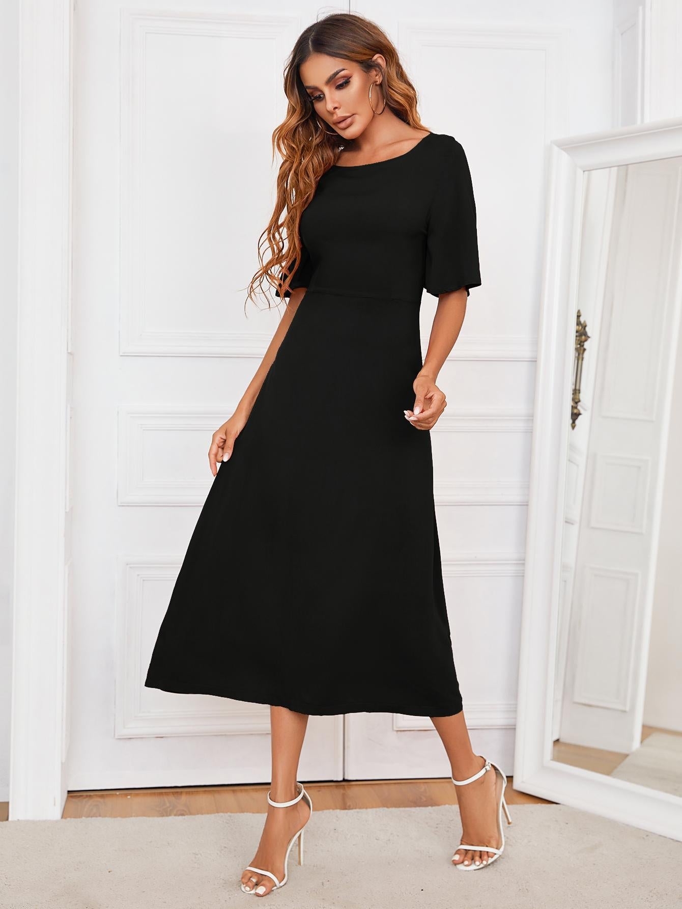 Black midi dress with short sleeves and A-line skirt, featuring a keyhole back detail.