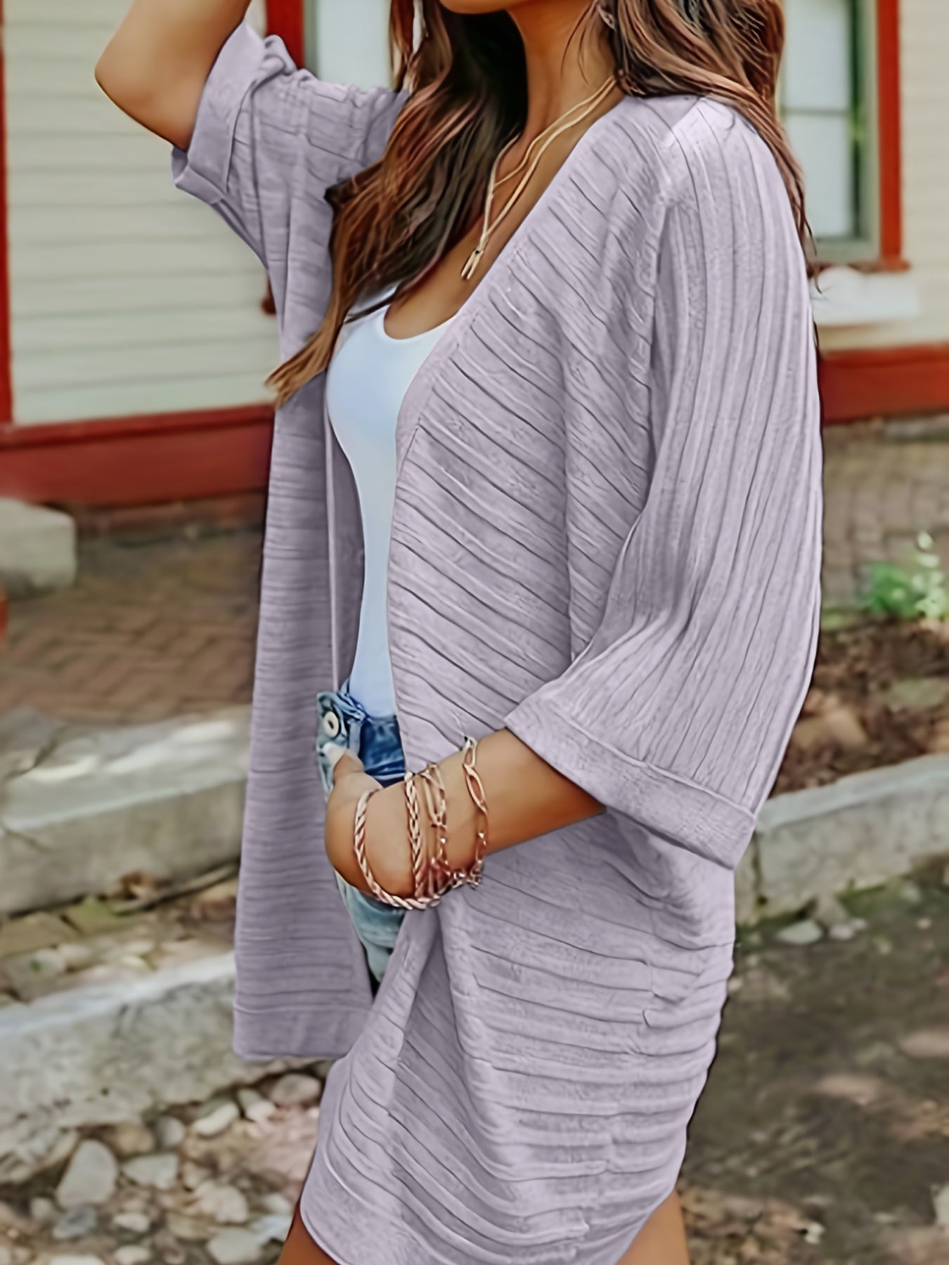 Textured ribbed sleeve cardigan in light purple with open front and elbow-length sleeves.