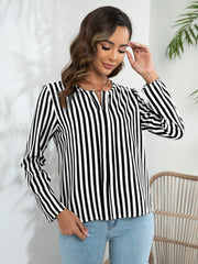 Vertical stripe blouse with keyhole neckline and long sleeves in black and white.