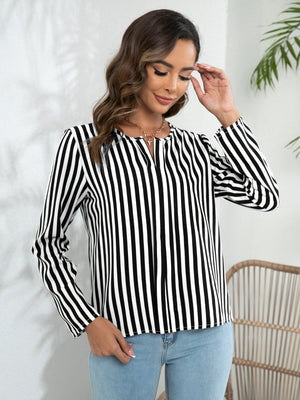 Vertical stripe blouse with keyhole neckline and long sleeves in black and white.