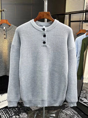 Light gray ribbed knit sweater with button detail at the neckline.