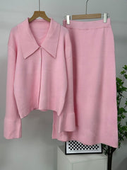 Pink ribbed knit cardigan with collar and button-down front, paired with a matching knit skirt.