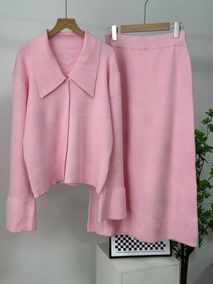 Pink ribbed knit cardigan with collar and button-down front, paired with a matching knit skirt.