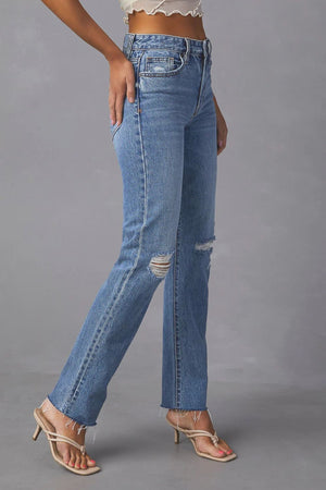 Medium wash distressed straight leg denim jeans with ripped knees and frayed hem.