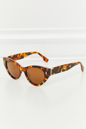 Cat-eye tortoise shell acetate sunglasses with brown lenses and gold accents.
