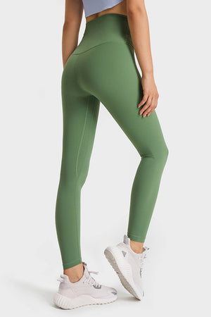 Green high rise leggings with subtle seam detail on the leg