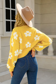 Yellow fuzzy cropped cardigan with white floral pattern, long sleeves, and a relaxed fit.