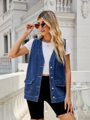 Utility denim vest in medium dark wash with button front and chest pockets.