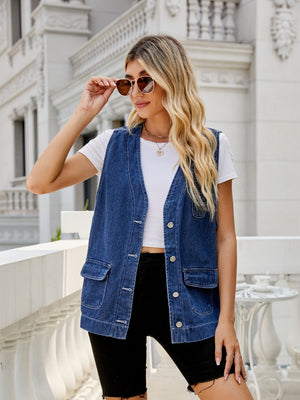 Utility denim vest in medium dark wash with button front and chest pockets.