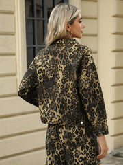 Leopard print denim jacket with button closure and collar.