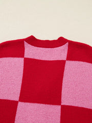 Checkerboard knit cardigan in deep rose and pink with a crew neck.