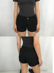 Black cargo shorts with button fly and elastic waistband, featuring side pockets.