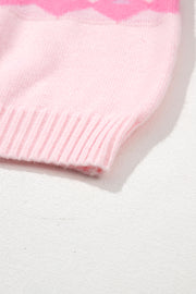 Pink acrylic knit sweater with diamond pattern and ribbed hem detail.