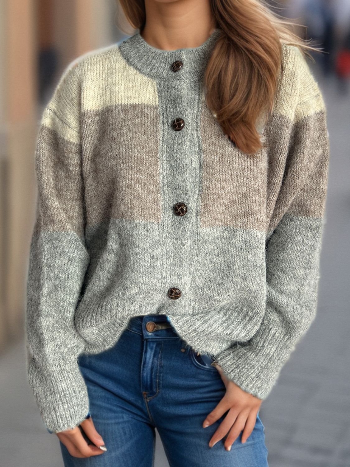 Colorblock crewneck button-down knit cardigan in gray, beige, and dusty blue acrylic with brown buttons.