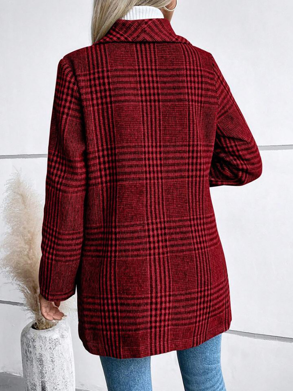 Burgundy plaid tailored overcoat with a single button closure and notched lapel.