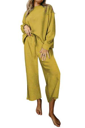 Yellow loungewear set with drop sleeves and wide-leg pants featuring a textured pattern.