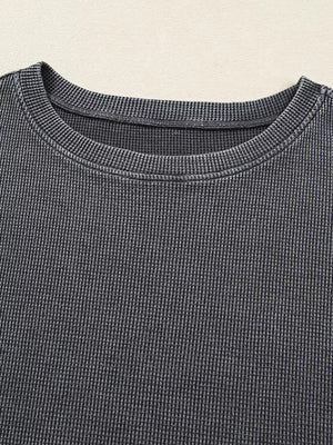 Textured dark gray waffle knit oversized sweatshirt with crew neck.