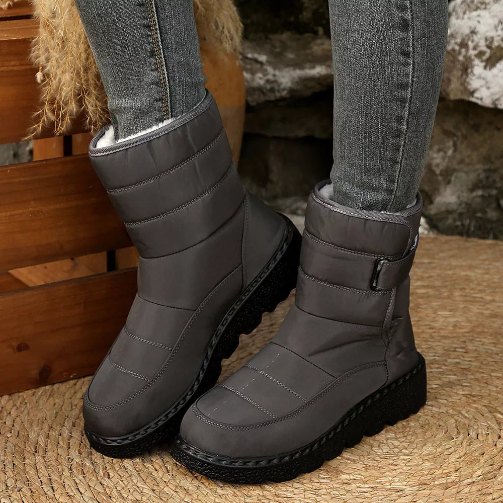 Gray quilted round toe platform boots with adjustable strap and chunky sole.