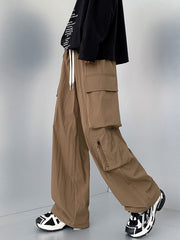 Men's camel cargo sweatpants with drawstring and zippered pockets.