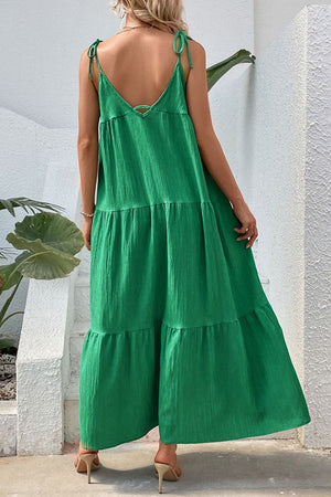 Green tiered maxi dress with tie straps and a textured fabric.