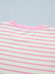 Ruffled short-sleeve blouse in white and pink stripes with a pink neckline.