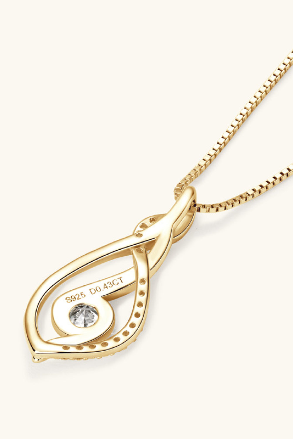 Gold infinity swirl pendant necklace with moissanite and small accent stones.