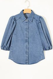 Denim maternity blouse with voluminous puff sleeves, collared neckline, and button-down front.