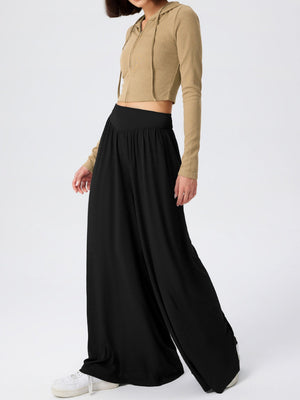 Black jersey wide-leg trousers with a drape-front detail and high waist.