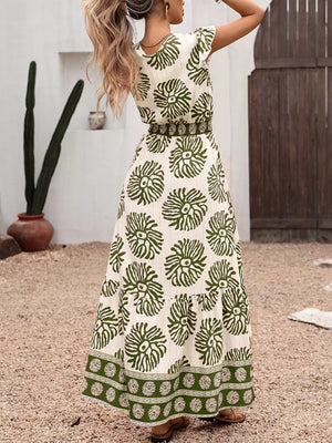 Botanical print V-neck maxi dress in cream with green botanical pattern, cap sleeves, and border print hem.