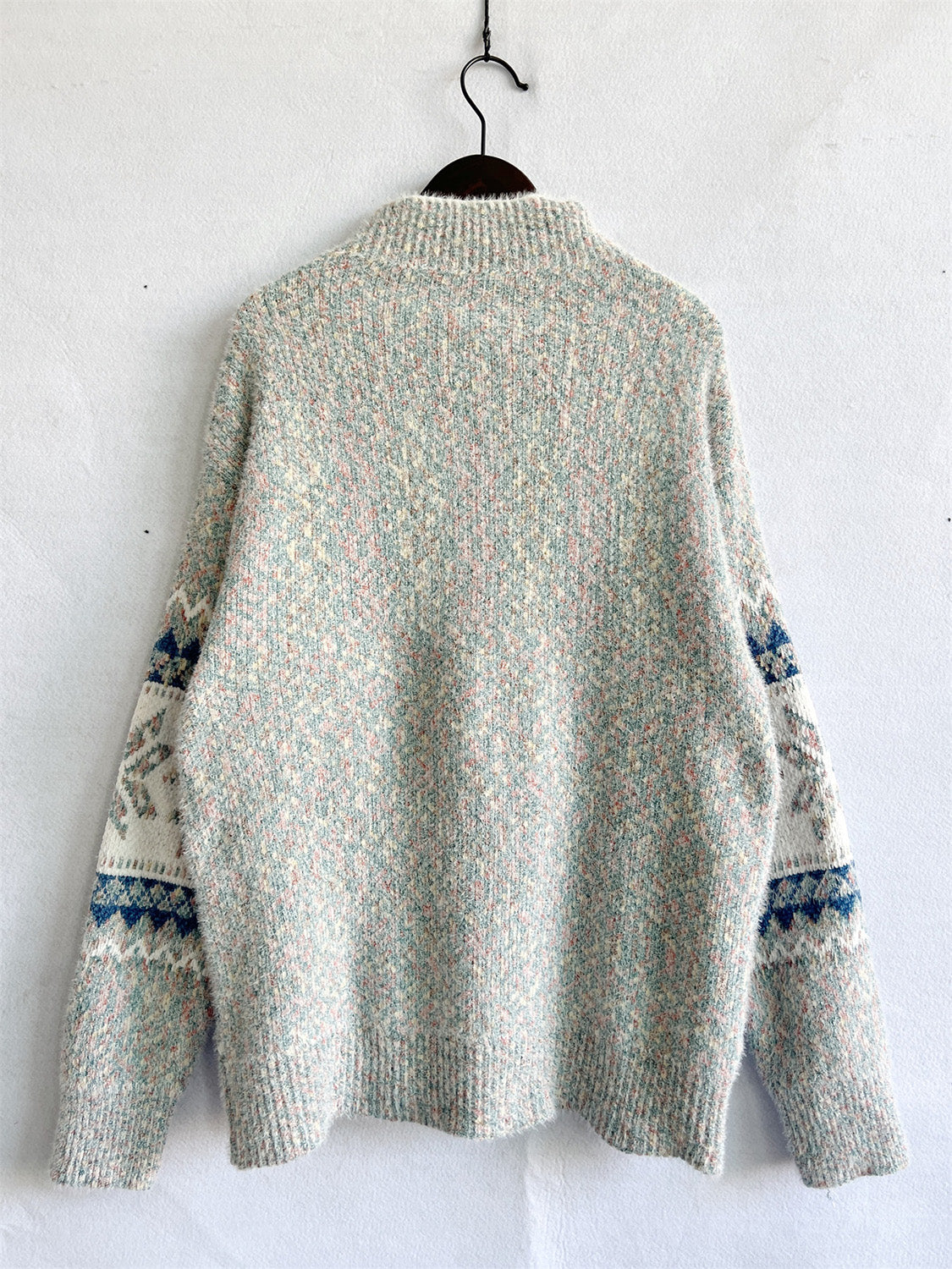 Geometric knit mockneck pullover sweater in pastel multi-color with fair isle sleeves.