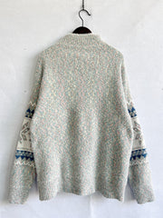 Geometric knit mockneck pullover sweater in pastel multi-color with fair isle sleeves.