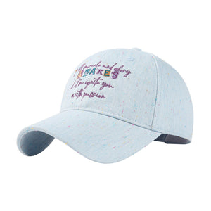 Light blue cotton baseball cap with embroidered text and colorful speckles.