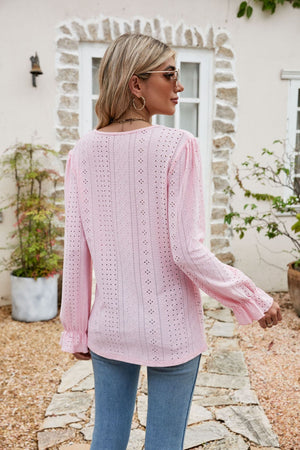 Blush pink eyelet lace blouse with ruffle sleeves and cuffs.