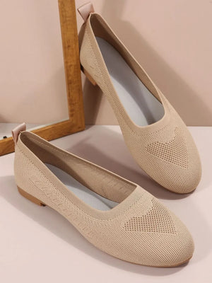 Beige knit ballet flats with subtle diamond pattern detail and pull tab.