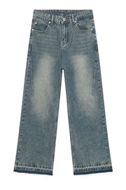 Distressed wide-leg denim jeans in medium wash with a raw hem.
