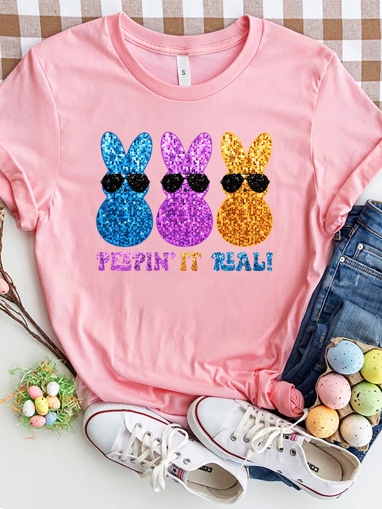 Pink t-shirt with three glitter bunnies in sunglasses and Peepin' It Real text graphic.