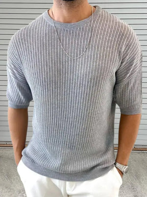 Gray open-knit sweater with boxy sleeves and a crew neck.