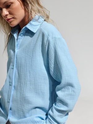 Light blue textured cotton overshirt with relaxed fit and button front.