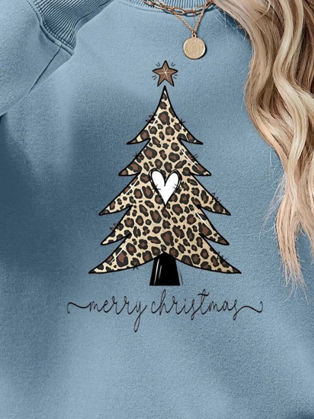 Misty Blue sweatshirt with leopard print Christmas tree graphic and Merry Christmas text.