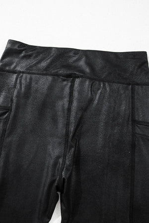 Black faux leather leggings with textured finish and side pockets.