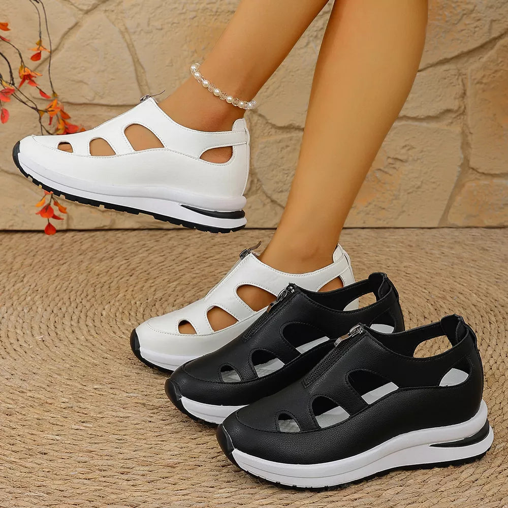 Chic cutout wedge sneakers in black and white with zipper detail and chunky sole.