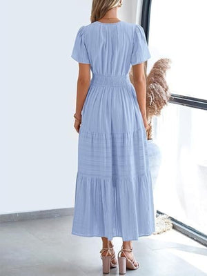 Light blue V-neck tiered maxi dress with short puff sleeves and smocked waist detail