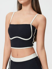 Black contour-trimmed crop top with white piping and spaghetti straps