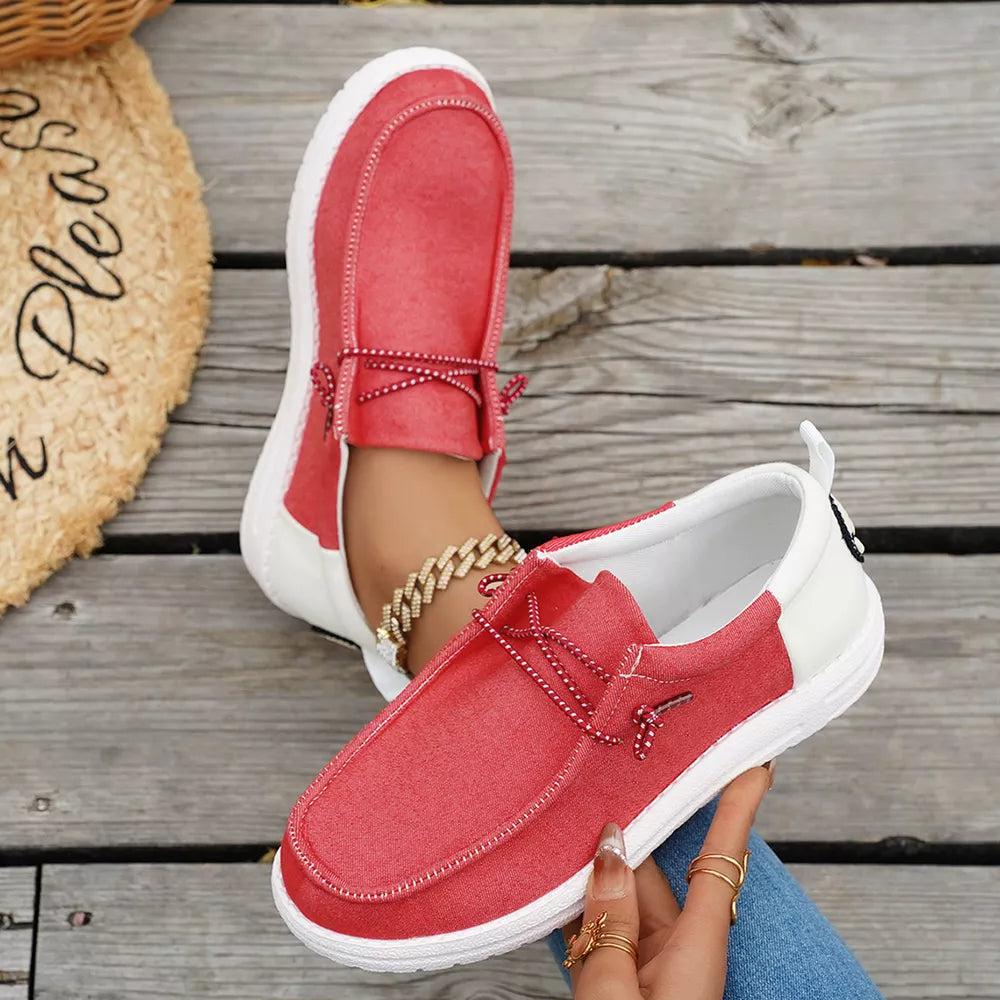 Red and white casual slip-on shoes with red laces and white soles.